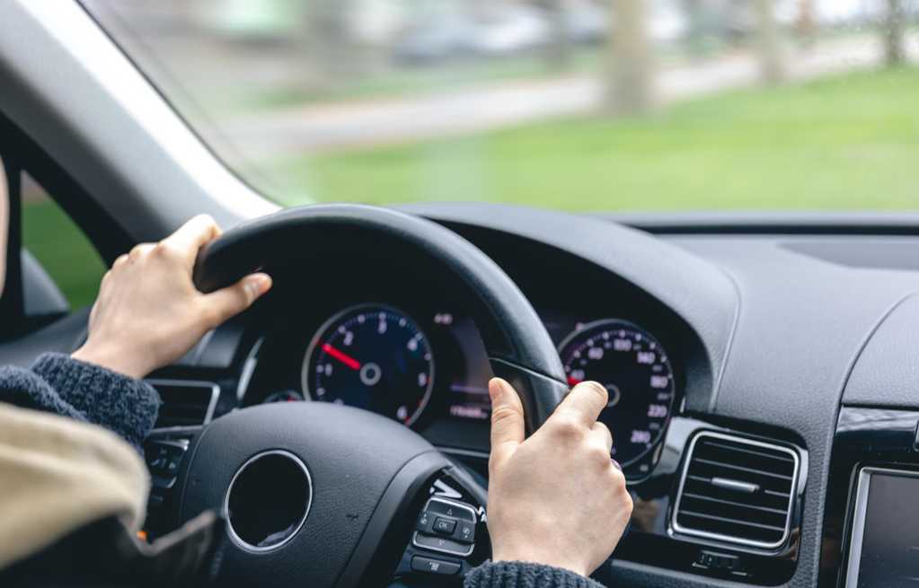 woman drivers hands car steering wheel